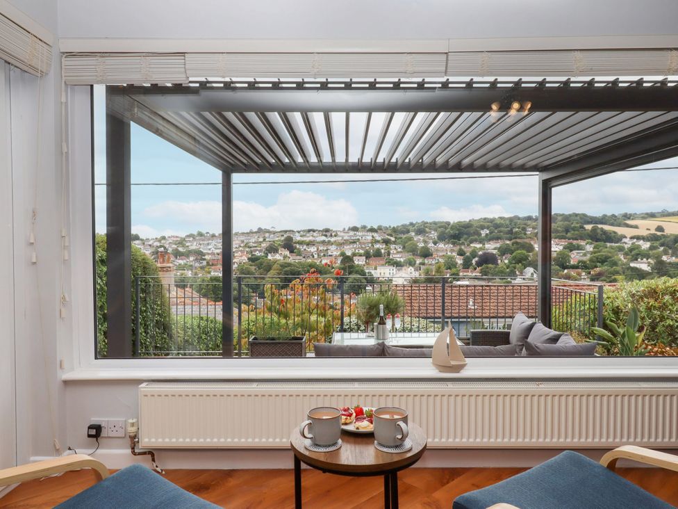 A sitting area with a view overlooking a village at 15 Summerland Avenue Dawlish