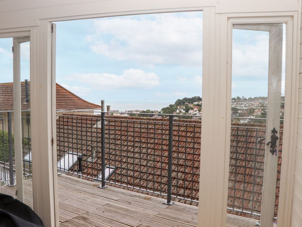 A view from a balcony showing rooftops and the sky at 15 Summerland Avenue Dawlish