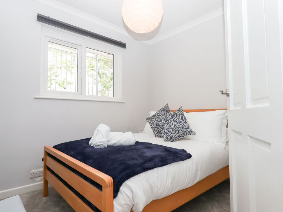 A bedroom with a bed and pillows at 15 Summerland Avenue Dawlish