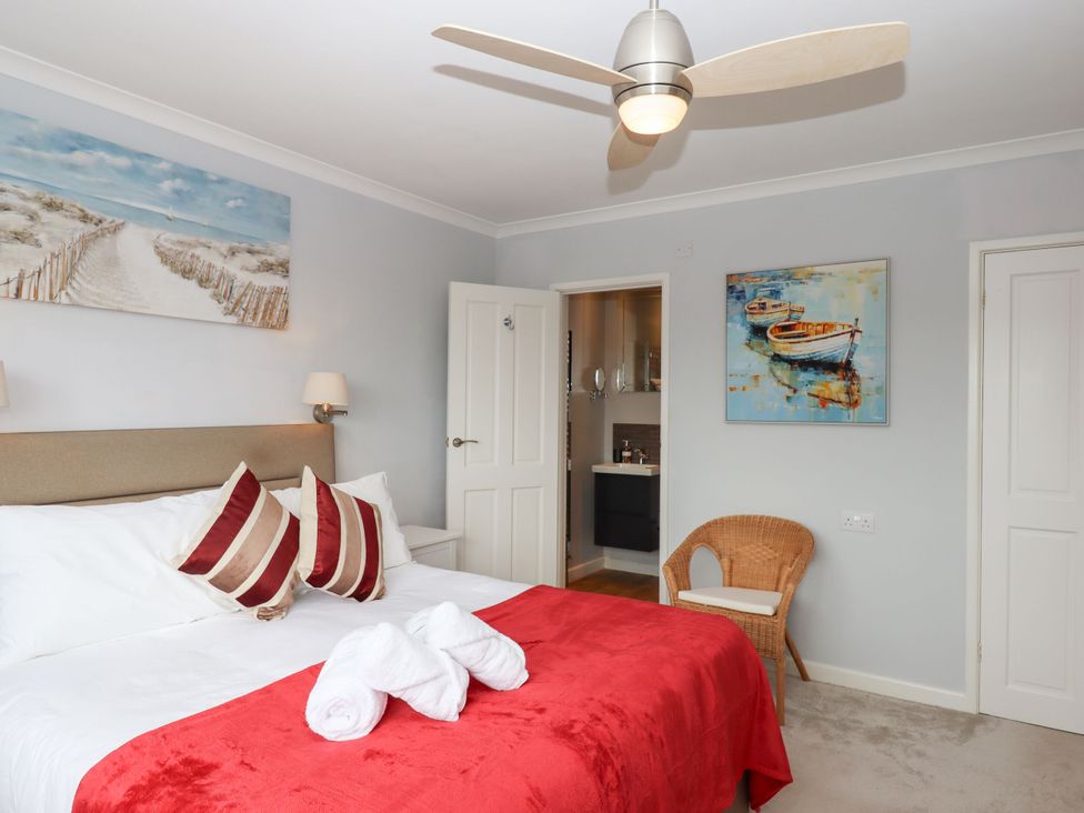 A bedroom with a bed and artwork at 15 Summerland Avenue in Dawlish