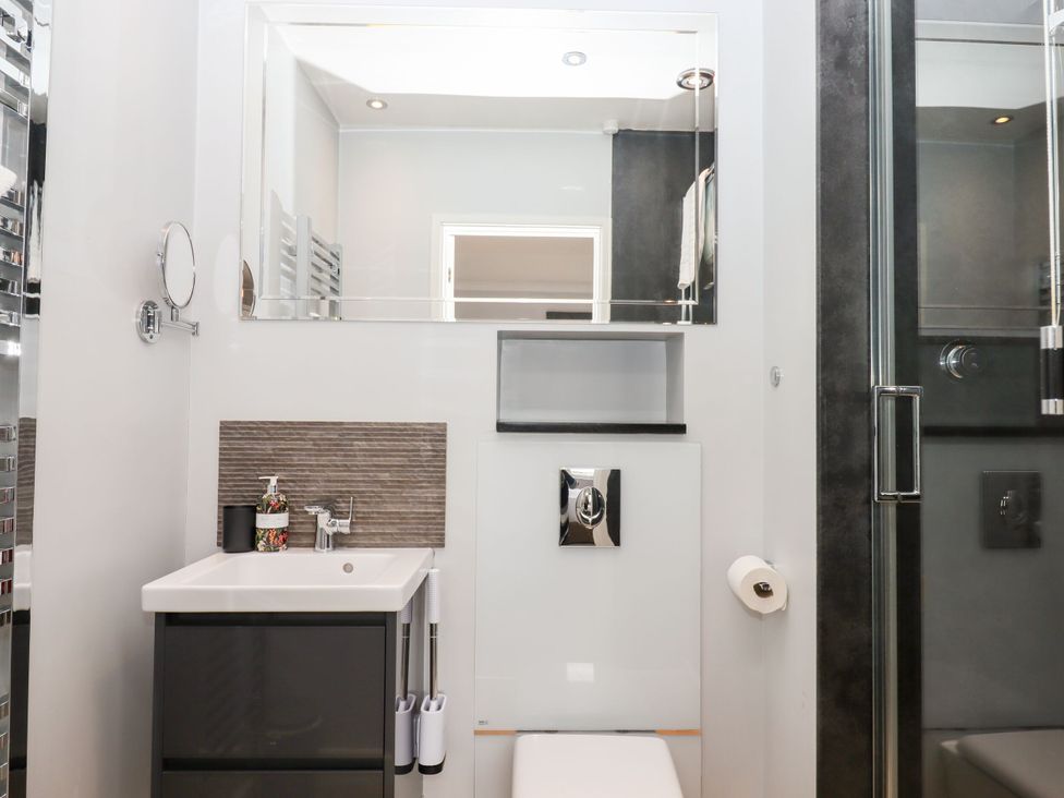 A bathroom featuring a sink and toilet at 15 Summerland Avenue Dawlish