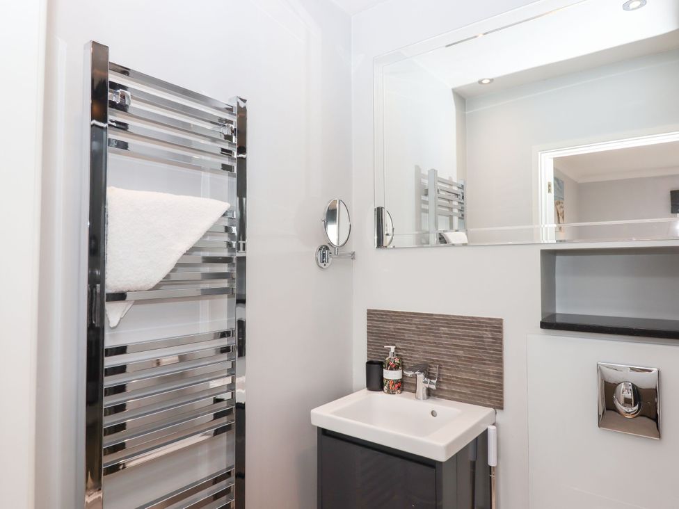 A bathroom featuring a heated towel rail and a sink at 15 Summerland Avenue Dawlish