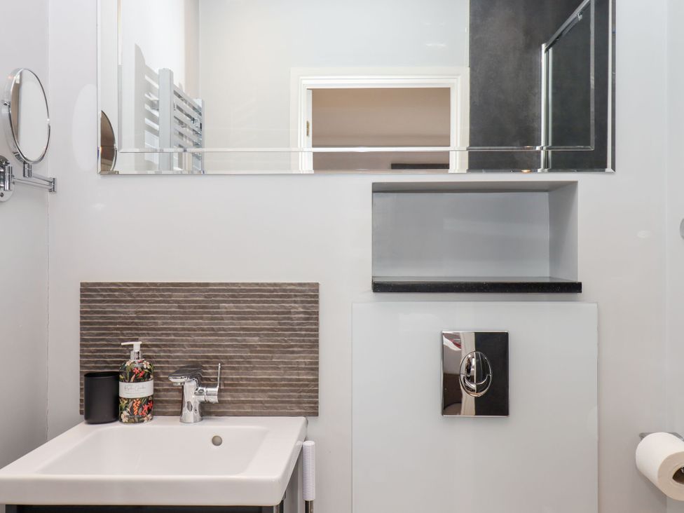 A bathroom with a sink and mirror at 15 Summerland Avenue, Dawlish