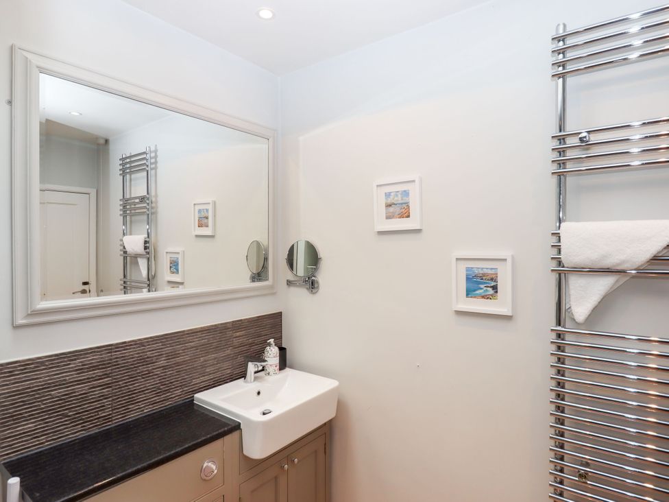 A bathroom with a basin and towel rack at 15 Summerland Avenue, Dawlish