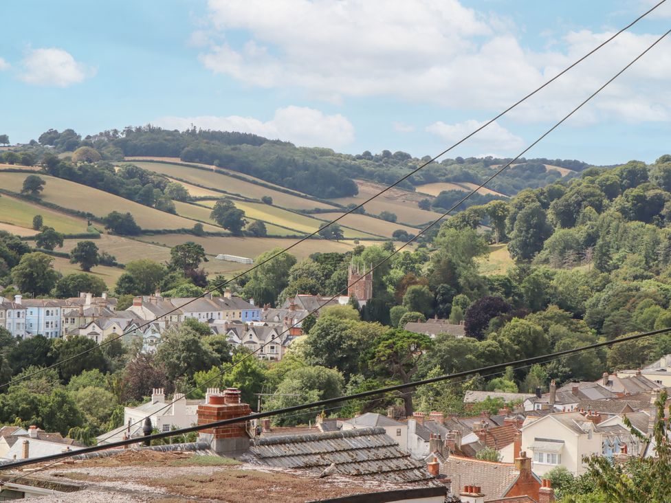 A view of houses and hills with power lines at 15 Summerland Avenue Dawlish