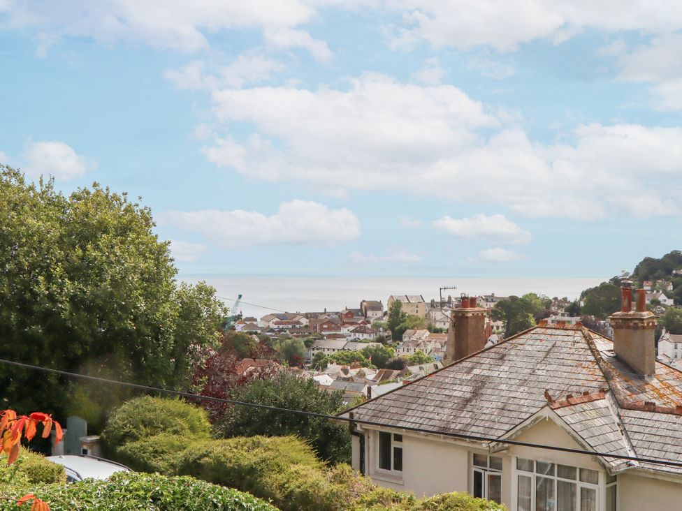 A view of the sea and houses from a hillside at 15 Summerland Avenue Dawlish