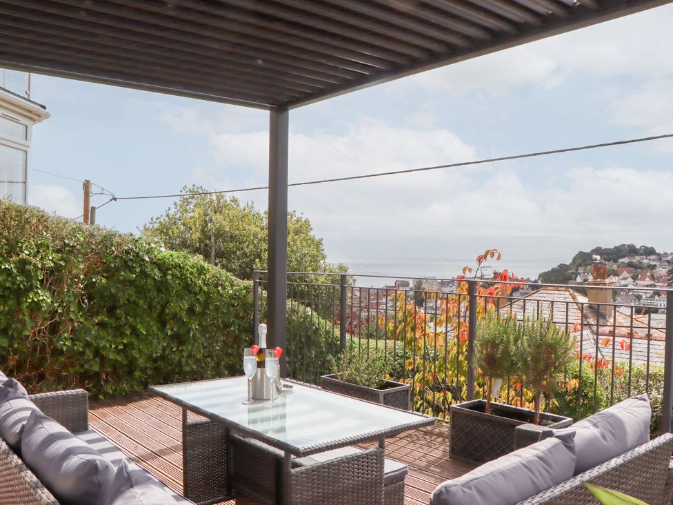 An outdoor seating area with a table and view at 15 Summerland Avenue Dawlish