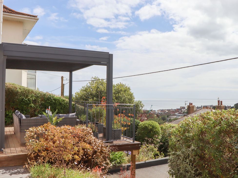 A garden with outdoor seating and a view of the landscape at 15 Summerland Avenue Dawlish