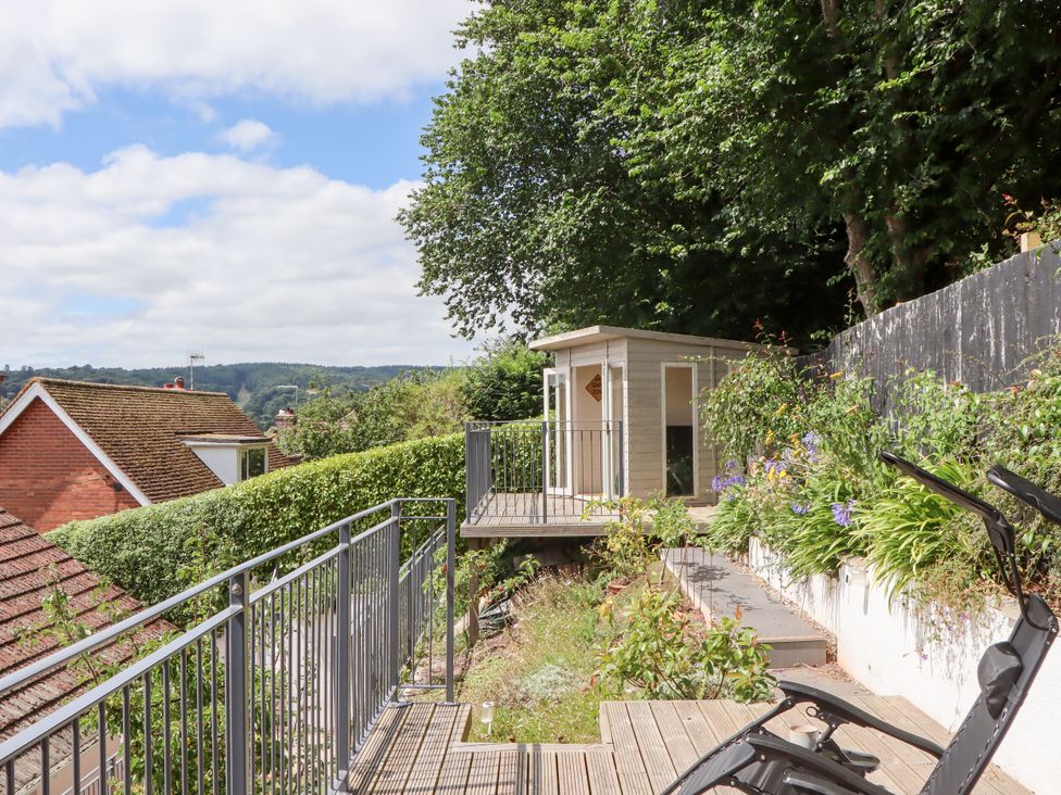 A garden with a shed and deck at 15 Summerland Avenue Dawlish