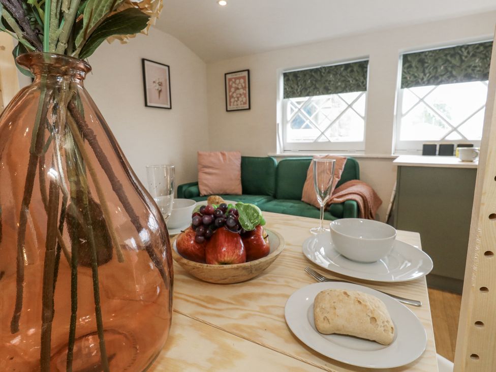 A living room with a fruit bowl and vase at Sea Pink Studio Swanage