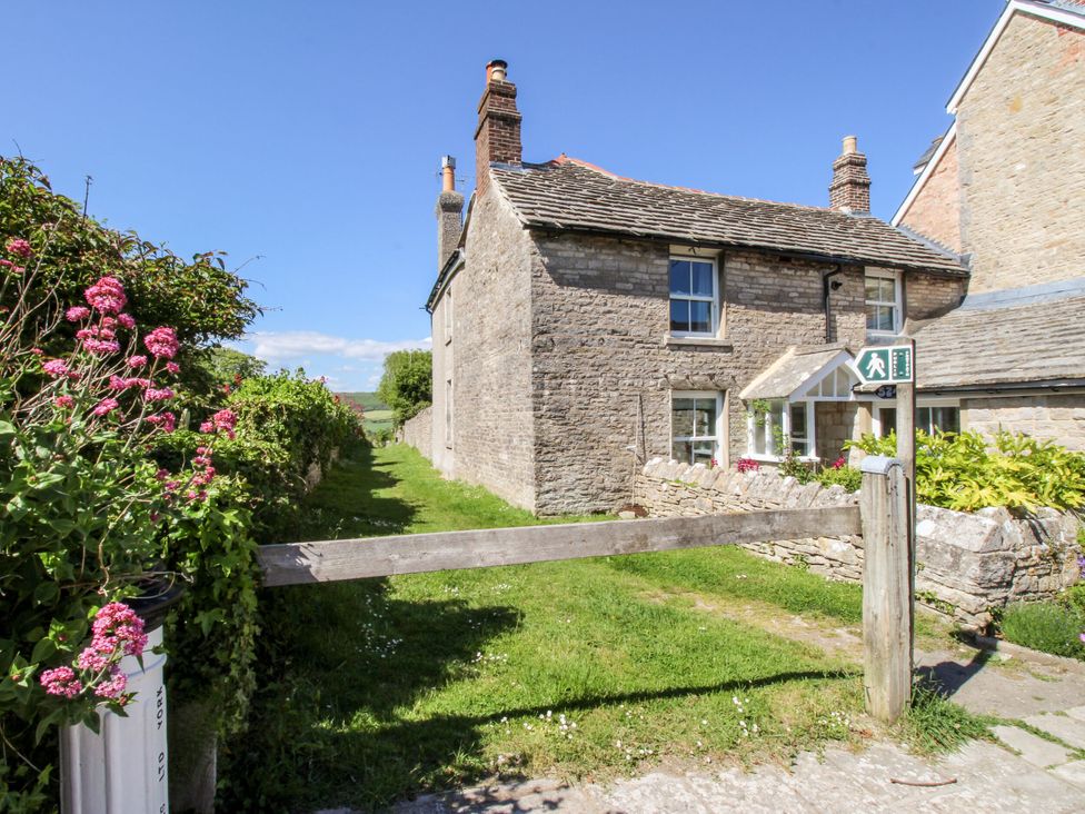 A house with flowers and a pathway at Sea Pink Studio in Swanage