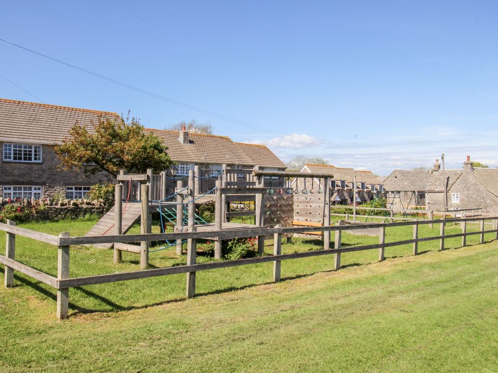 A playground with climbing frame and slide at Sea Pink Studio in Swanage