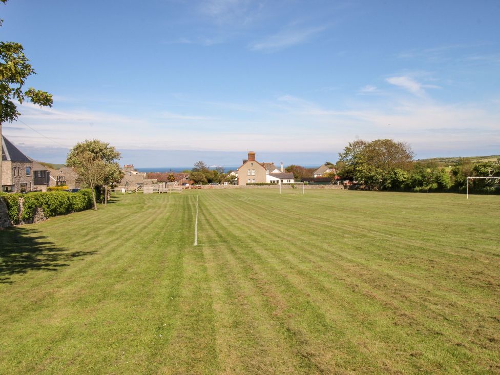 A field with goal posts and houses in the background at Sea Pink Studio in Swanage