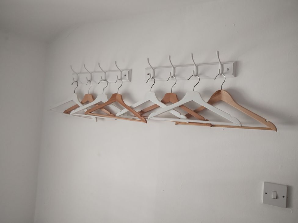 A wall display of clothes hangers at Llety in Beddgelert