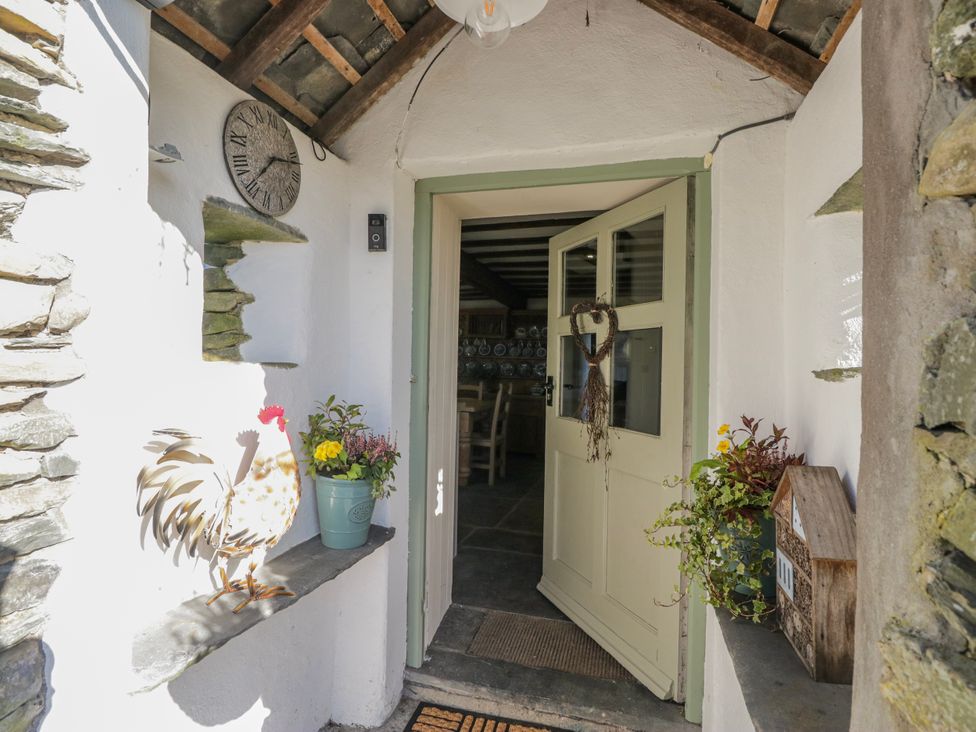An entrance with a door and plants at High Ickenthwaite Farmhouse in Ulverston