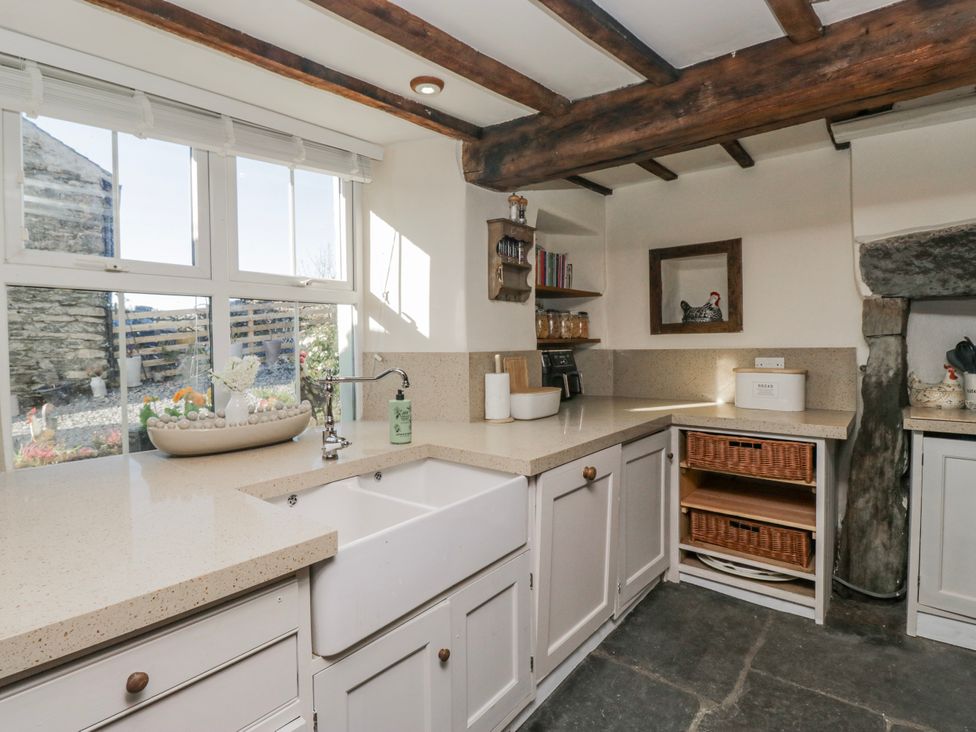 A kitchen with sink and countertops at High Ickenthwaite Farmhouse in Ulverston