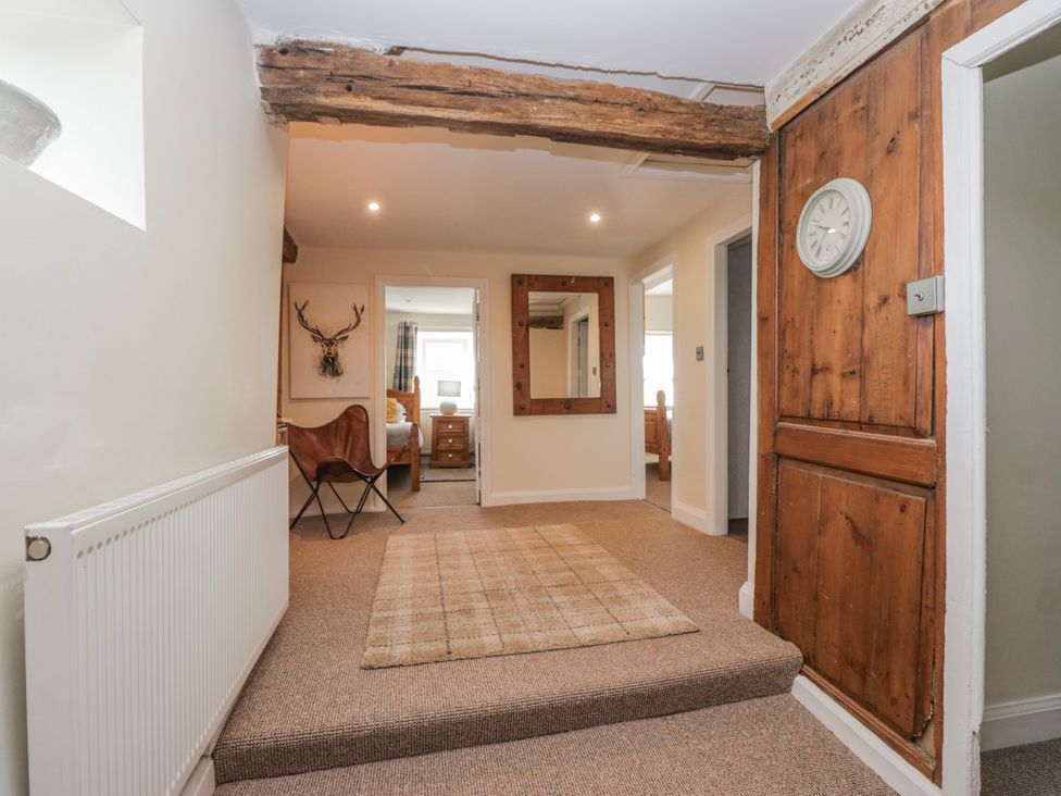 A hallway with a radiator and a mirror at High Ickenthwaite Farmhouse in Ulverston