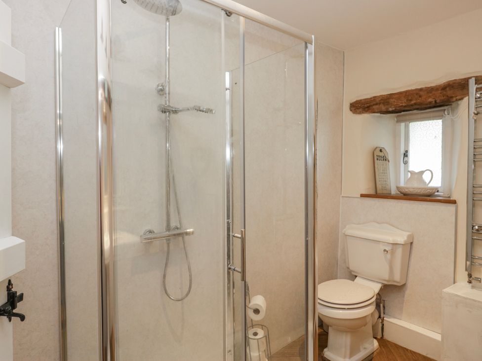 A bathroom with a shower and toilet at High Ickenthwaite Farmhouse in Ulverston