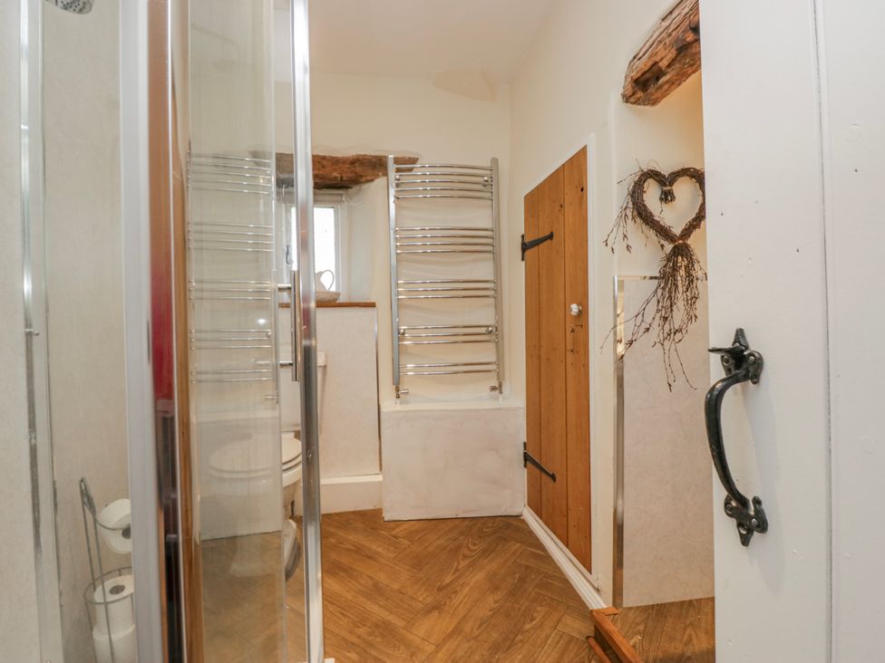 A bathroom with a shower and bathtub at High Ickenthwaite Farmhouse, Ulverston