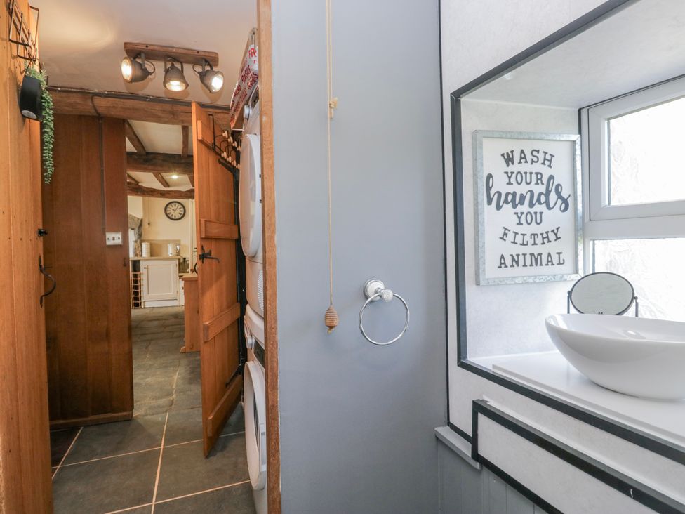 A bathroom with a sink and towel ring at High Ickenthwaite Farmhouse in Ulverston