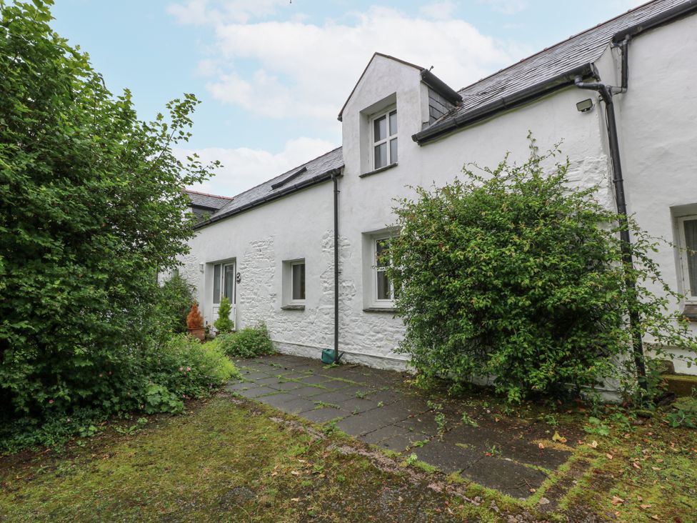 A house with a pathway and bushes at The Steading in Castle Douglas