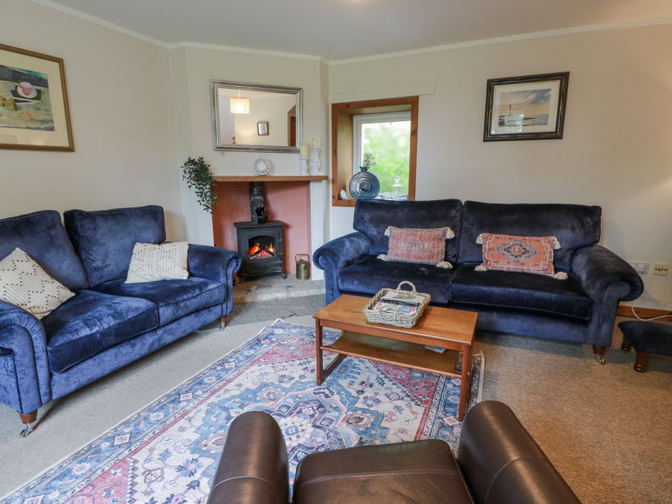A living room with sofas and a fireplace at The Steading in Castle Douglas