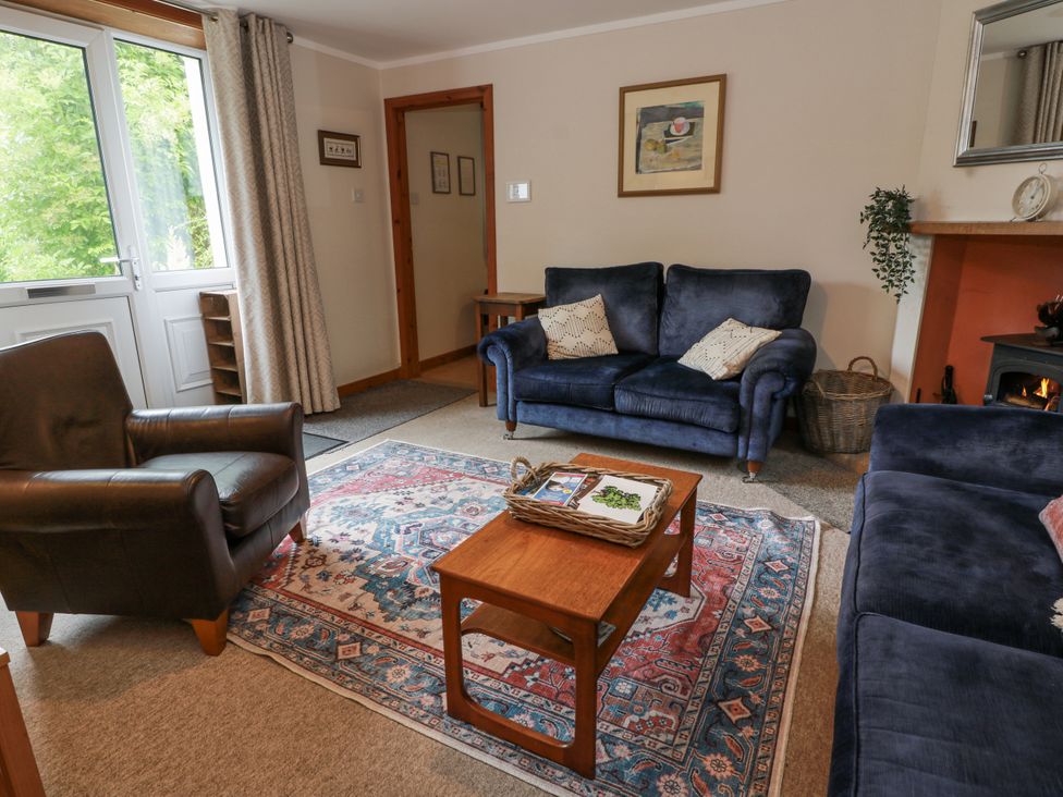 A living room with a sofa and armchair at The Steading in Castle Douglas