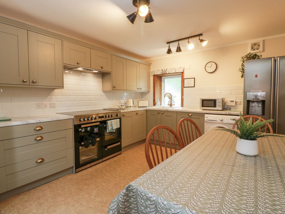 A kitchen with cabinets and appliances at The Steading in Castle Douglas