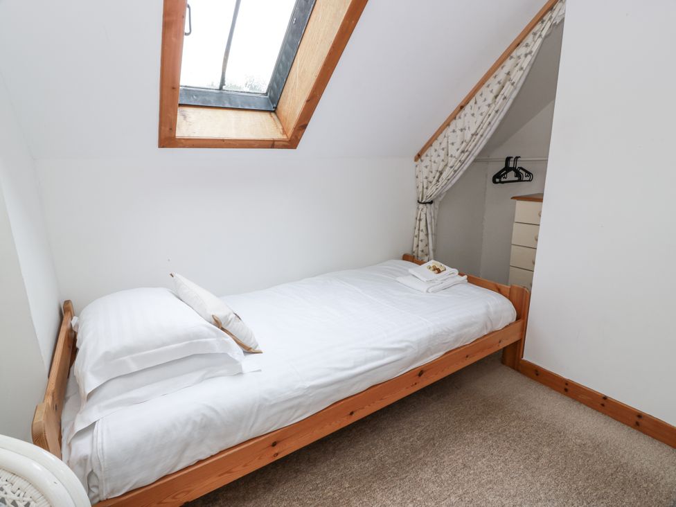 A bedroom with a bed and a dresser at The Steading Castle Douglas