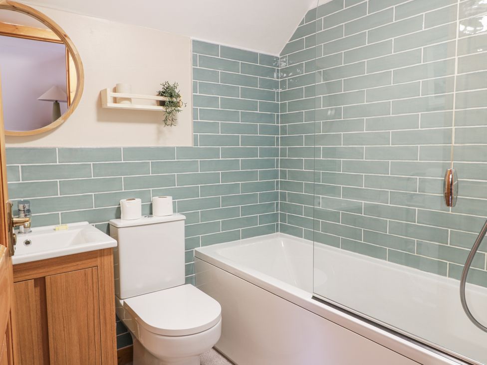 A bathroom with a shower, toilet, and sink at The Steading in Castle Douglas