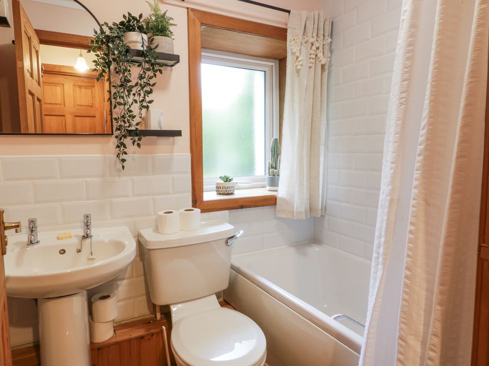 A bathroom with a sink, toilet, and bathtub at The Steading in Castle Douglas