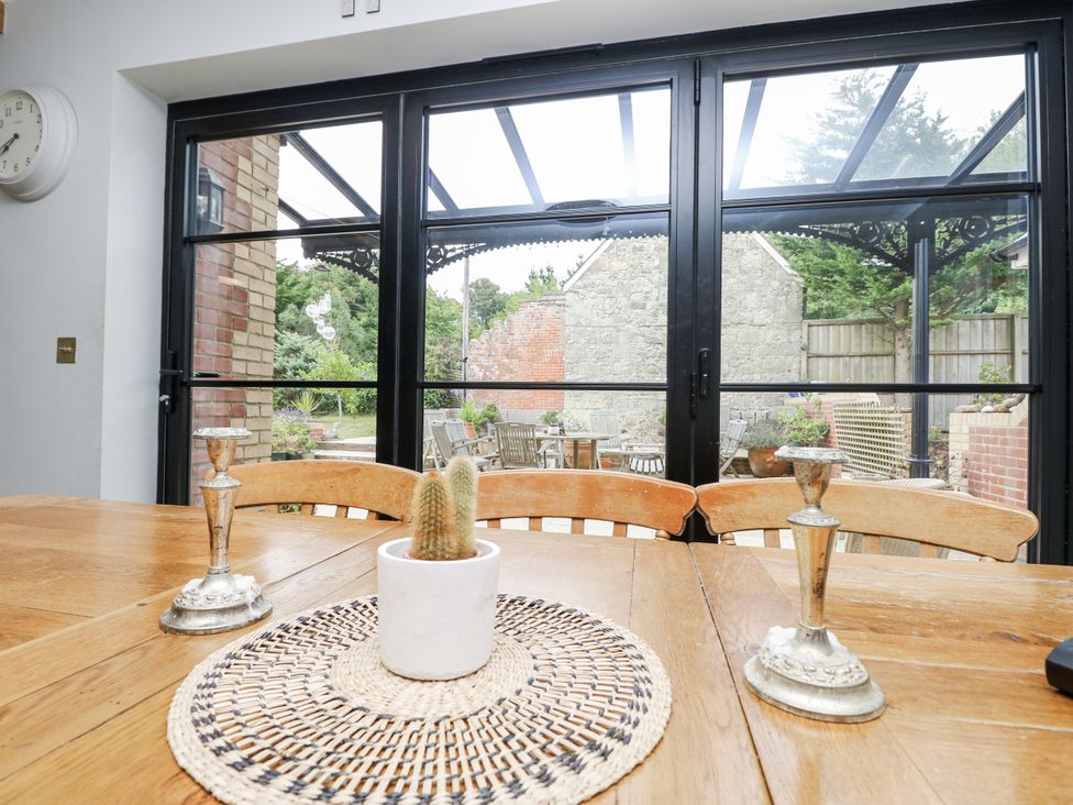 A dining room with a table and candlesticks at Milston in Chale