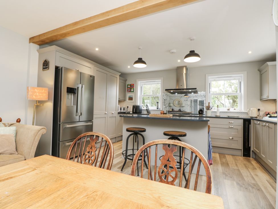 A kitchen with appliances and dining area at Milston in Chale