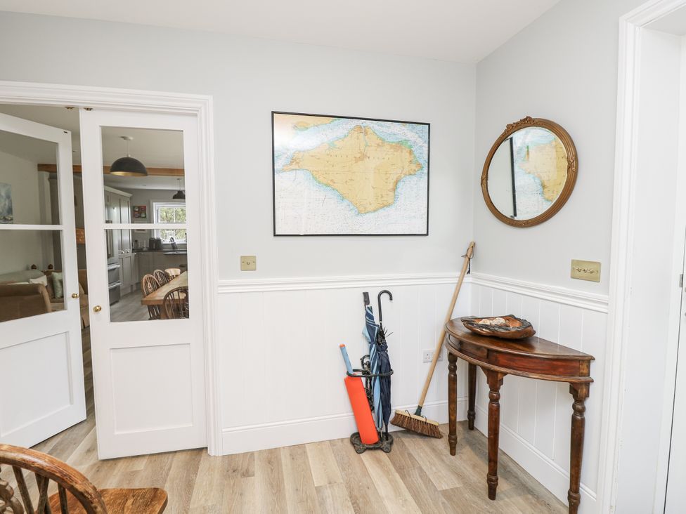 A hallway with a map and a table at Milston in Chale