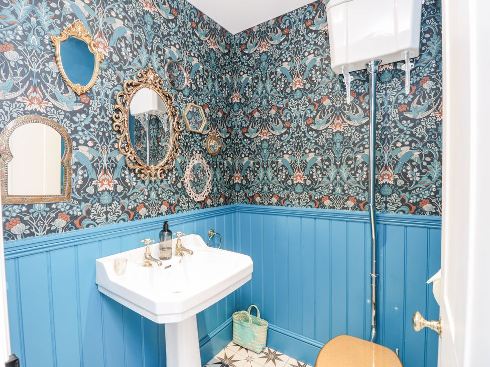 A bathroom with a sink and mirrors at Milston in Chale