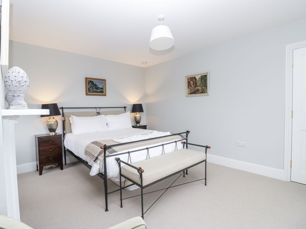 A bedroom with a bed and bedside tables at Milston in Chale