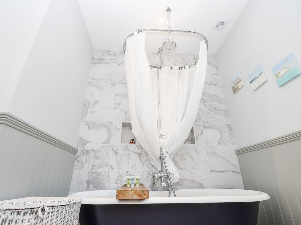 A bathroom with a bathtub and shower at Milston in Chale