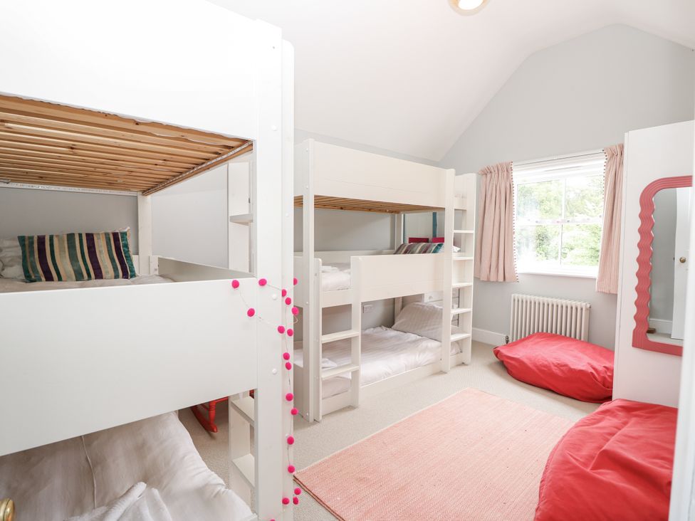 A bedroom with bunk beds and bean bags at Milston Chale
