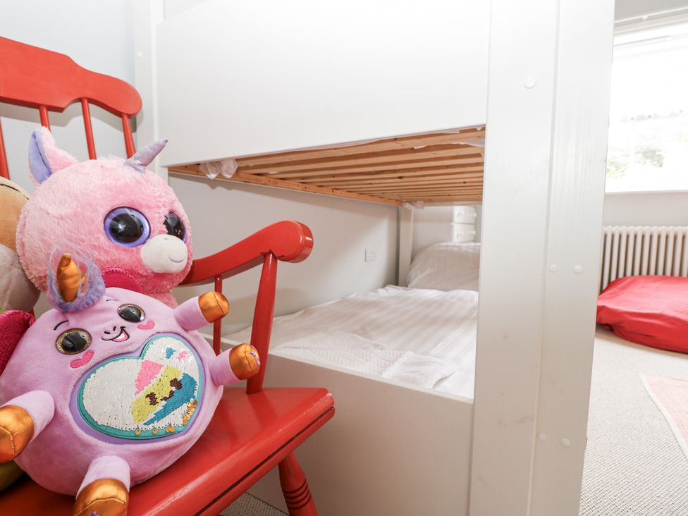 A bedroom with a bunk bed and stuffed animals at Milston in Chale