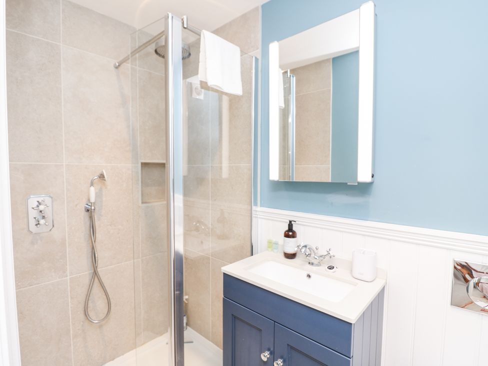 A bathroom with a shower and sink at Milston in Chale