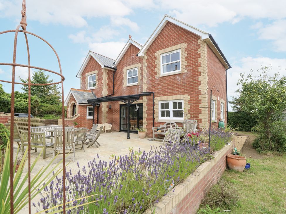 A house with outdoor furniture and lavender in the garden at Milston in Chale