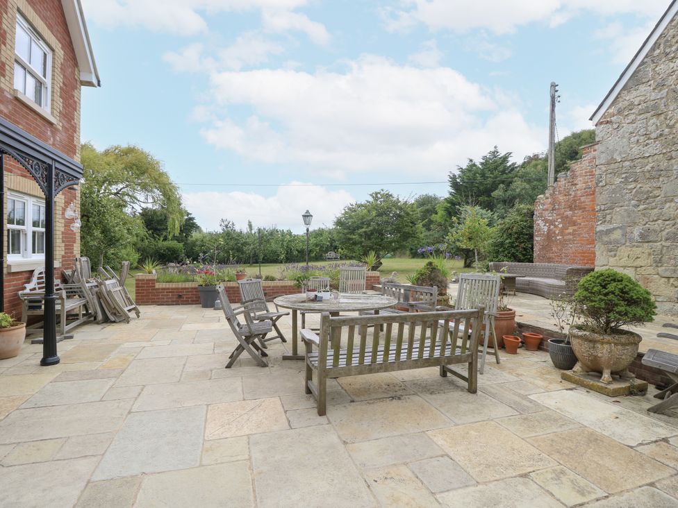 An outdoor patio with seating and plants at Milston in Chale