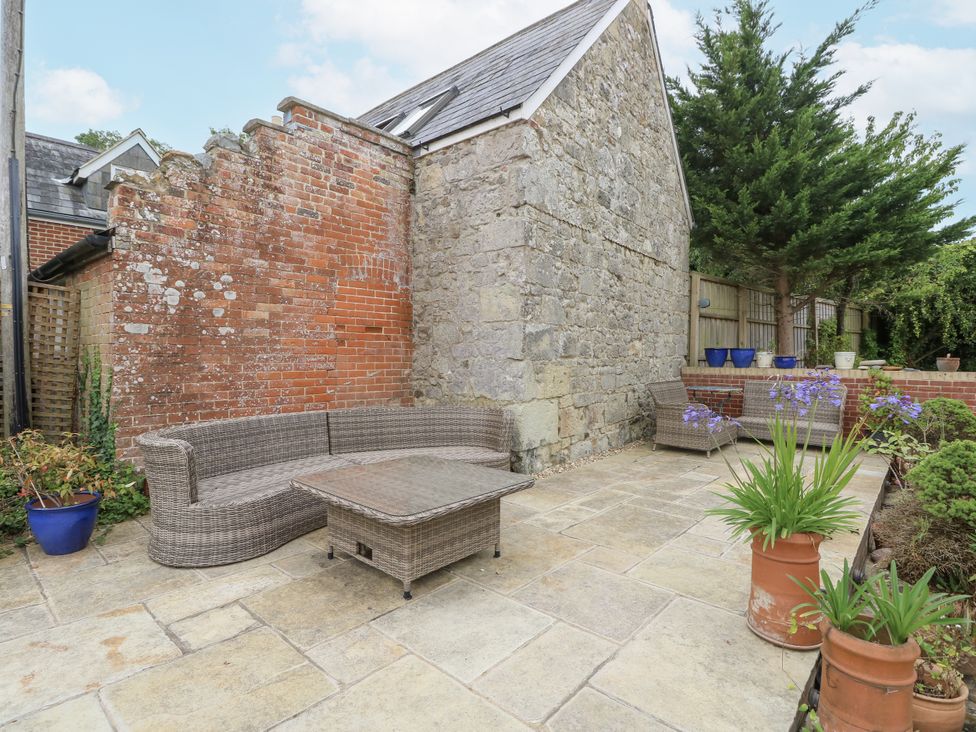A garden area with a sofa and coffee table at Milston in Chale