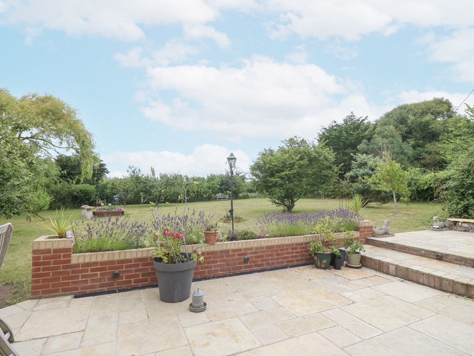 A garden with flowers and planters at Milston in Chale