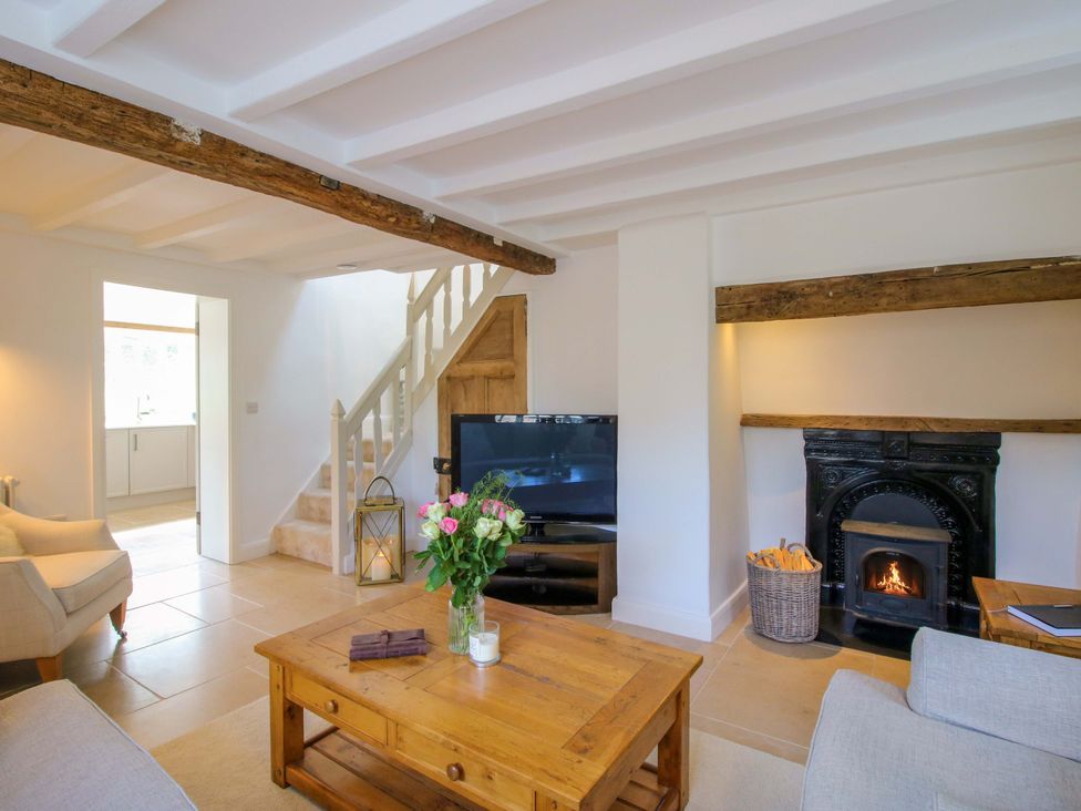 A living room with a television and fireplace at 5 Shrewsbury Road in Much Wenlock