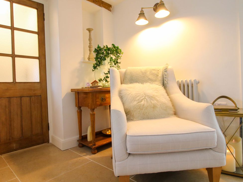 A living room with a chair and a table at 5 Shrewsbury Road Much Wenlock