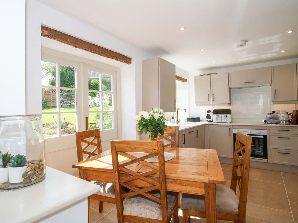 A kitchen with a dining table and chairs at 5 Shrewsbury Road in Much Wenlock