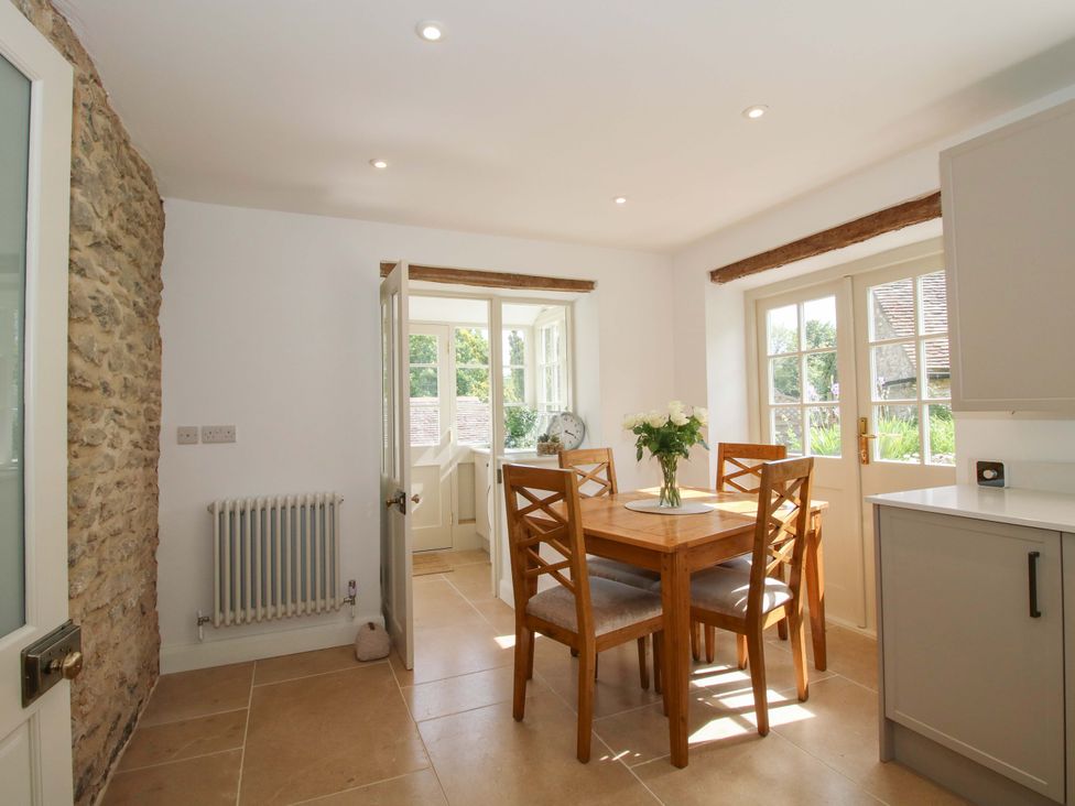 A kitchen with a table and chairs at 5 Shrewsbury Road in Much Wenlock
