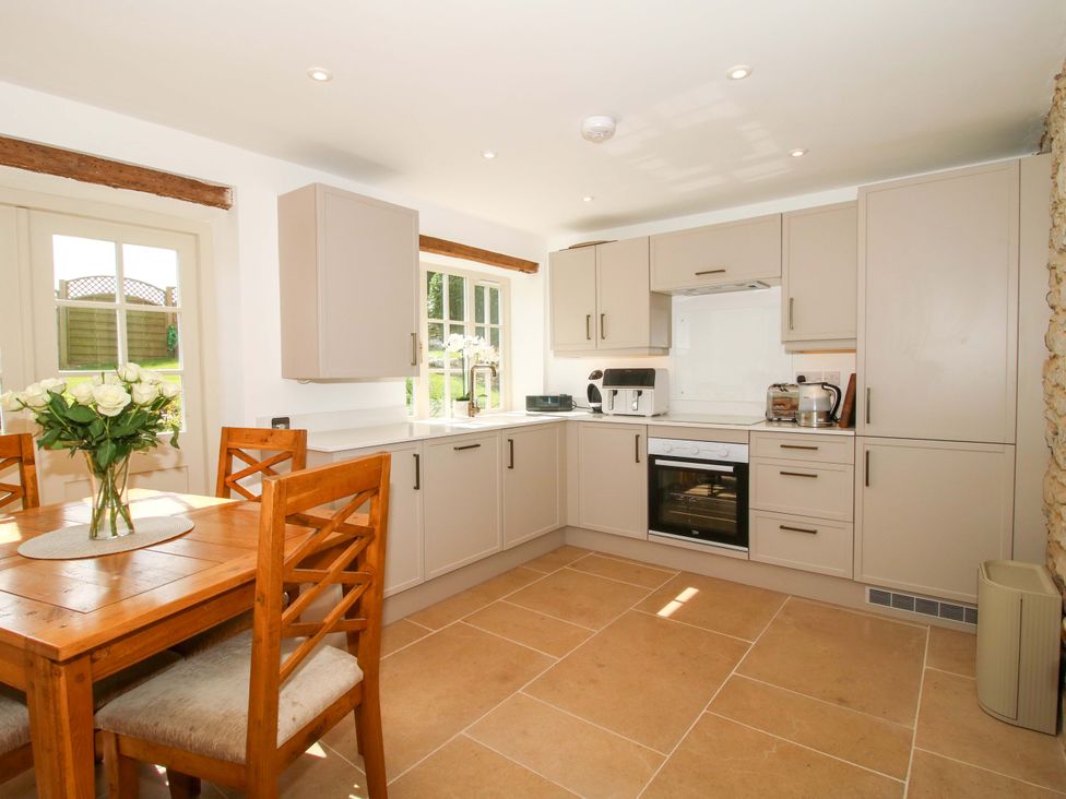 A kitchen with a dining table and chairs at 5 Shrewsbury Road in Much Wenlock
