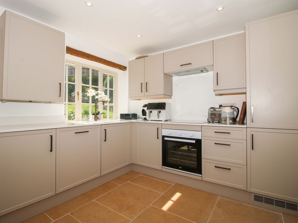 A kitchen with cabinets and appliances at 5 Shrewsbury Road Much Wenlock